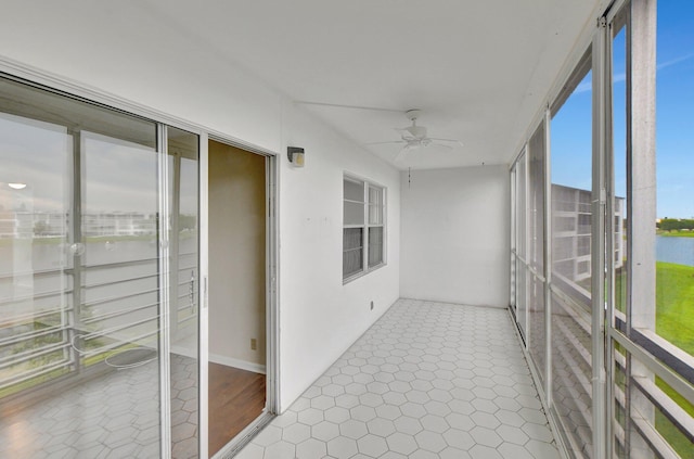 unfurnished sunroom with a wealth of natural light and ceiling fan