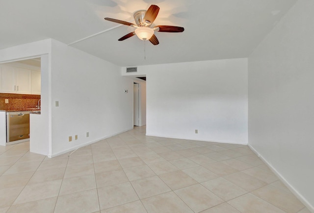 tiled empty room featuring ceiling fan