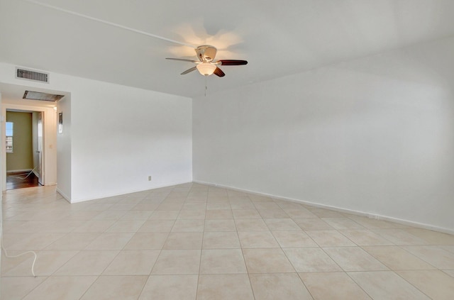 tiled spare room with ceiling fan