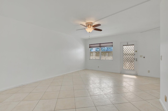 tiled empty room with ceiling fan