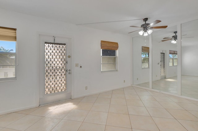 tiled empty room with ceiling fan