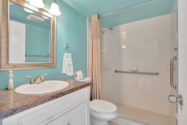 bathroom featuring vanity, toilet, and a shower with curtain