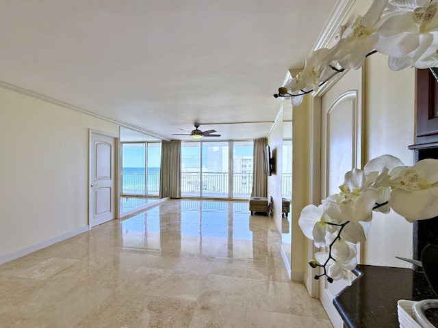 interior space with expansive windows, ornamental molding, and ceiling fan