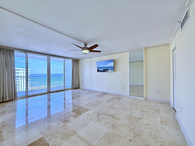 unfurnished room featuring expansive windows, ornamental molding, a water view, and ceiling fan