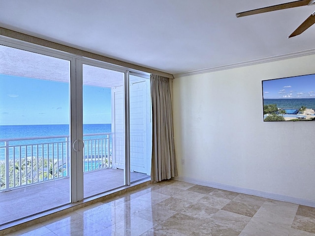 spare room with a water view, ceiling fan, ornamental molding, and floor to ceiling windows