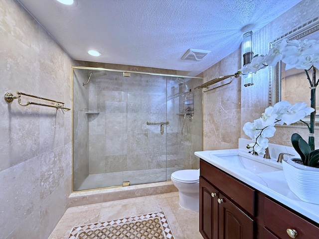 bathroom with walk in shower, vanity, toilet, and a textured ceiling