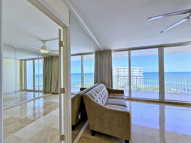 sunroom featuring a water view, a healthy amount of sunlight, and ceiling fan