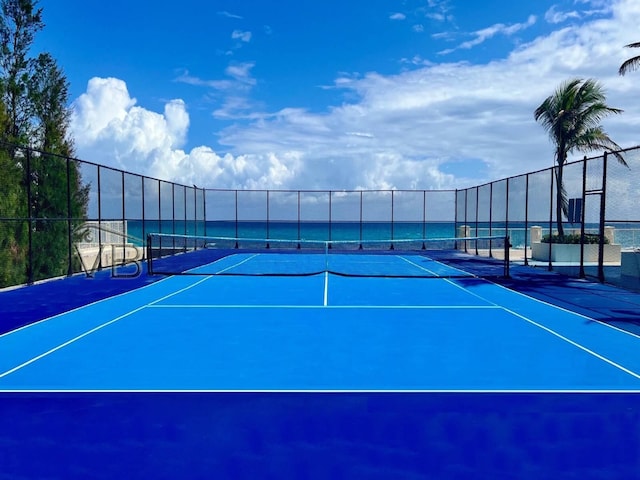 view of sport court with a water view