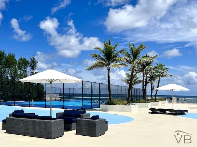 view of pool featuring a water view, outdoor lounge area, and tennis court