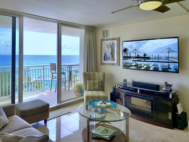 living room with light tile patterned floors, crown molding, ceiling fan, a water view, and expansive windows