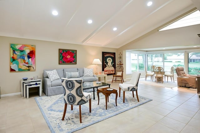 living room featuring a healthy amount of sunlight, vaulted ceiling, and light tile patterned flooring