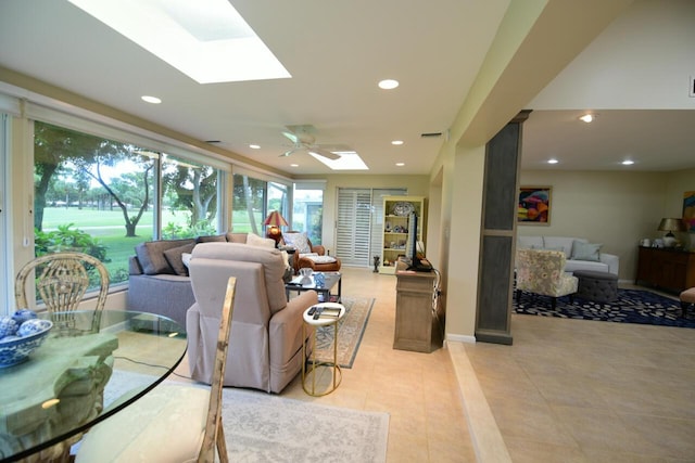 living area with a skylight, recessed lighting, light tile patterned floors, visible vents, and ceiling fan