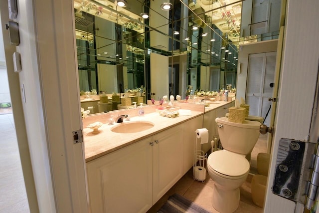 bathroom with vanity, toilet, and tile patterned floors