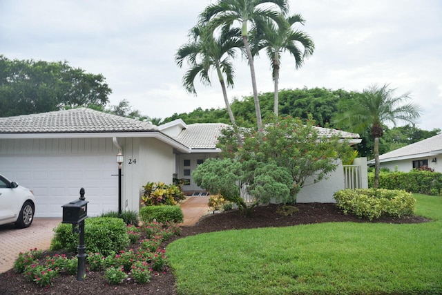 view of side of property with a yard and a garage