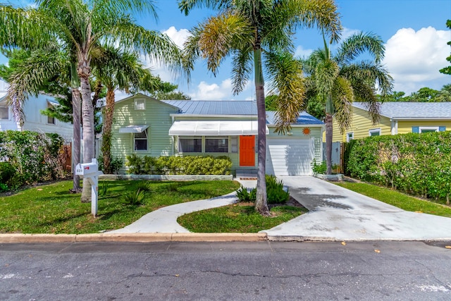 view of front of property with a garage and a front yard