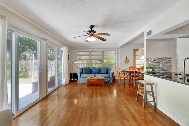 interior space featuring visible vents, a sink, and a ceiling fan