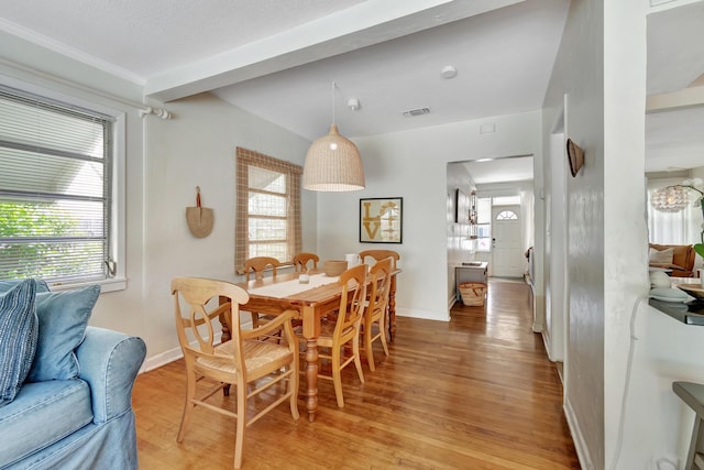 dining area with a healthy amount of sunlight, light wood-style flooring, and baseboards