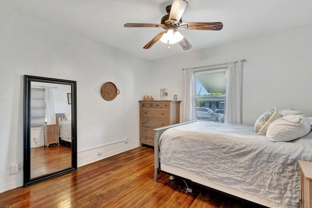 bedroom with wood-type flooring, baseboards, and ceiling fan