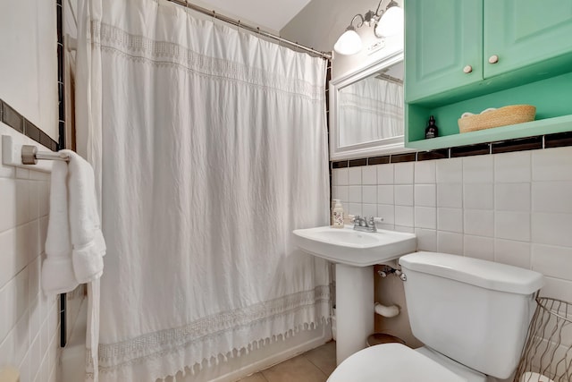 bathroom featuring backsplash, a shower with shower curtain, tile patterned flooring, tile walls, and toilet