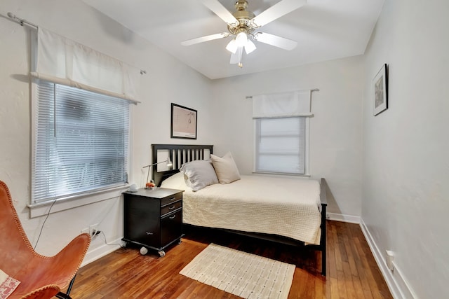 bedroom with hardwood / wood-style floors and ceiling fan