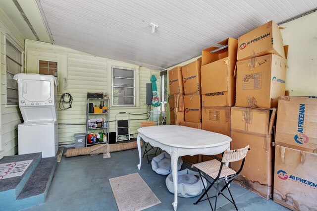 interior space featuring vaulted ceiling and stacked washer and dryer