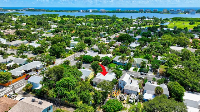 drone / aerial view with a water view and a residential view