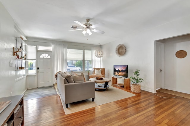 living room with ceiling fan and light hardwood / wood-style flooring