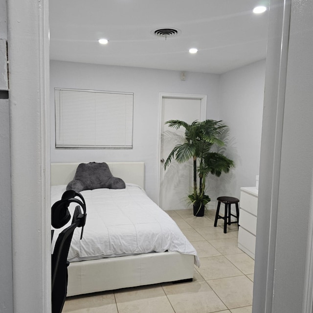 bedroom with light tile patterned floors