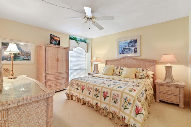 bedroom with light colored carpet and ceiling fan