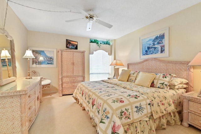 bedroom with light carpet and ceiling fan