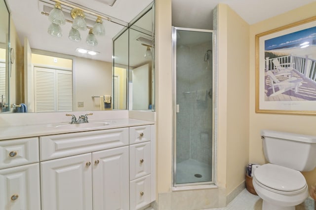 bathroom with vanity, toilet, and an enclosed shower