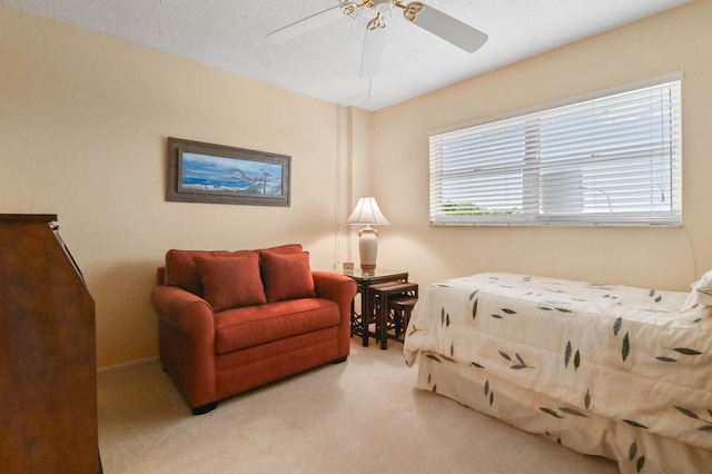 bedroom featuring light carpet and ceiling fan