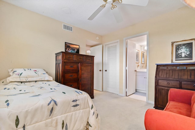 carpeted bedroom with a textured ceiling and ceiling fan