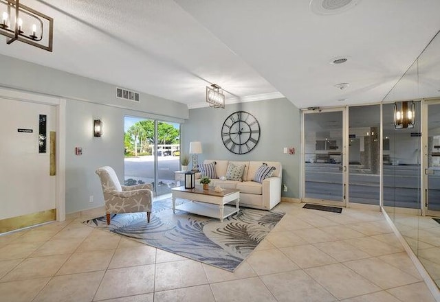 living room with crown molding and light tile patterned flooring