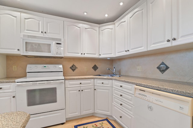 kitchen with light stone countertops, light tile patterned floors, white appliances, and white cabinetry