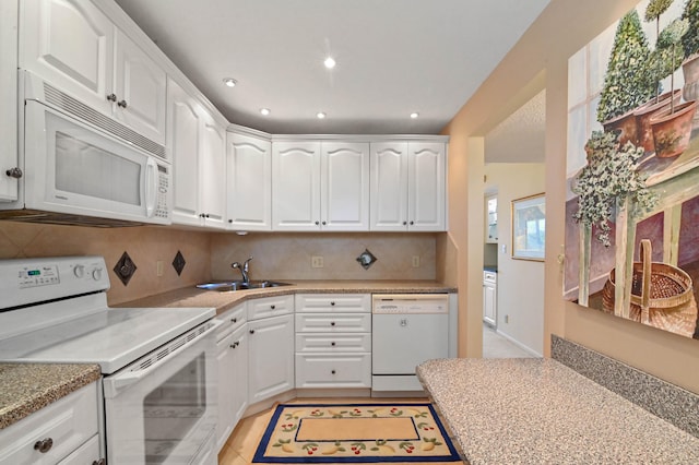 kitchen featuring white cabinets, white appliances, tasteful backsplash, and sink