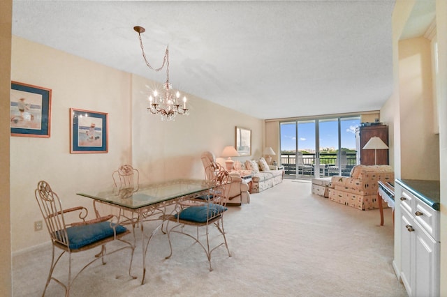 dining space with expansive windows, an inviting chandelier, light carpet, and a textured ceiling