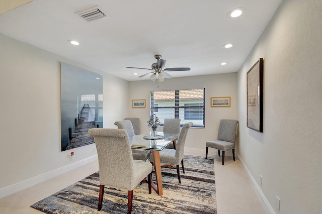 carpeted dining room featuring ceiling fan