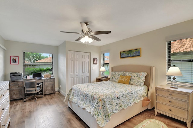 bedroom with a closet, light wood-type flooring, and ceiling fan