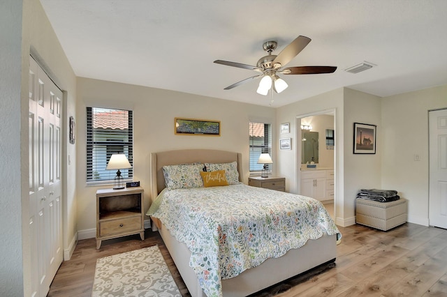 bedroom with a closet, ceiling fan, light hardwood / wood-style flooring, and ensuite bath