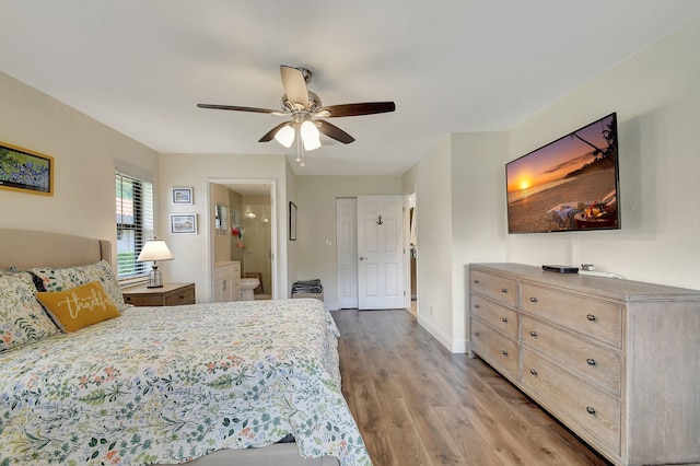 bedroom featuring connected bathroom, ceiling fan, and hardwood / wood-style floors