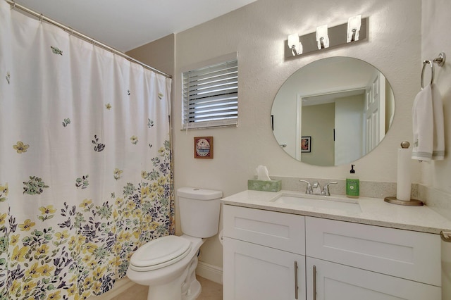 bathroom featuring vanity, a shower with shower curtain, and toilet