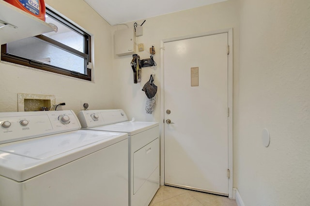 laundry area featuring light tile patterned flooring and washing machine and dryer