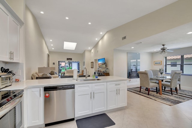 kitchen featuring ceiling fan, light tile patterned floors, white cabinetry, sink, and stainless steel appliances