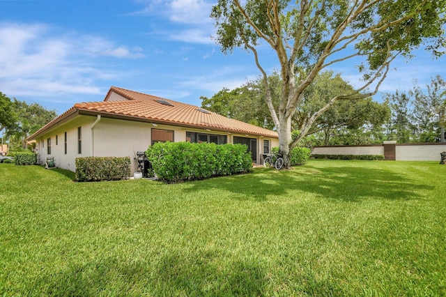 view of side of home featuring a lawn