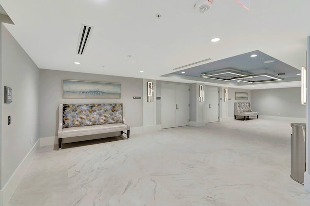 unfurnished room featuring a tray ceiling