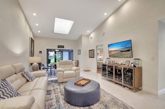 living room with high vaulted ceiling, tile patterned floors, and a skylight