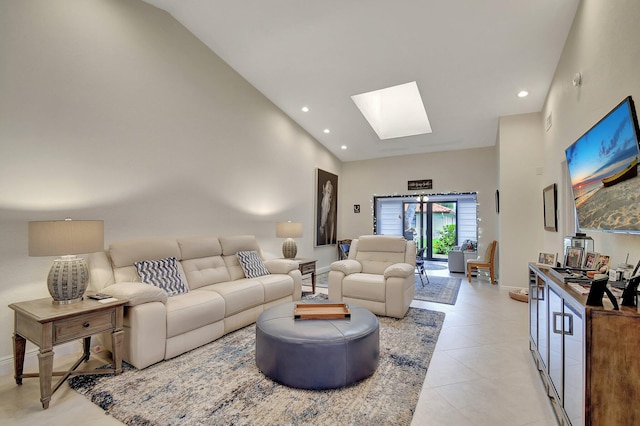 living room with high vaulted ceiling, a skylight, and light tile patterned floors