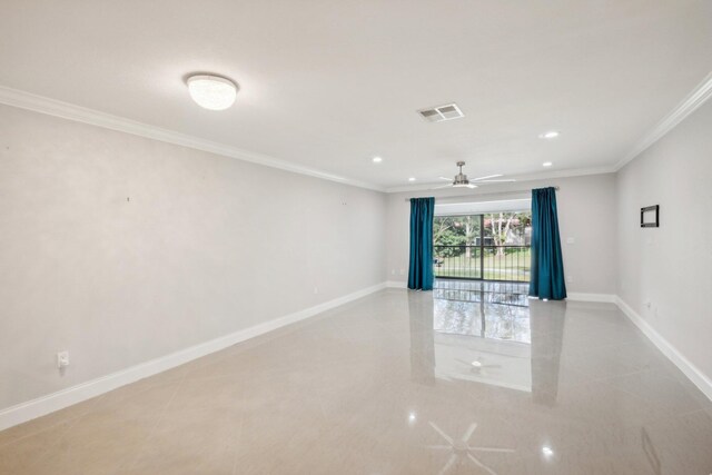 tiled spare room featuring ceiling fan and crown molding