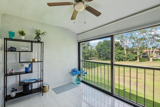 sunroom with ceiling fan and lofted ceiling